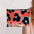 Close-up of leopard print canvas makeup bag with black zipper held by hand - Coral Black Teal Abstract Leopard Style (jiayingpbb0150)