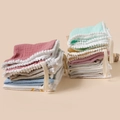 Detailed view of soft cotton muslin baby towels with pom-pom trim and hanging loops - Random Color
