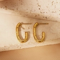 Close-up of golden U-shaped earrings with textured geometric triangle patterns - Geometric Texture U-Shaped Style