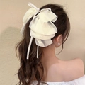 Elegant cream layered chiffon bow hair claw clip styled on a low ponytail - Cream White Chiffon Streamer Claw