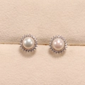 Elegant freshwater pearl stud earrings with zircon halo on beige velvet jewelry box - Stud Earrings