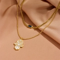 Double-layered gold necklace with Hamsa hand and blue gemstone pendant on champagne silk - Double Layer Pendant Necklace (C612)