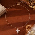 Elegant gold cross necklace with zircon stones on a vintage brown velvet backdrop - KC Gold 6679 Gold Large Cross Zircon Pendant Necklace