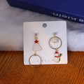 Detail of asymmetric Christmas earrings with Santa snowman and enamel tree motifs - Tree & Snowman Combo Style