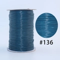 Dark blue waxed cord for jewelry making, shade #136, showing woven texture and spool - 136 Peacock Blue / 1.0mm 160m