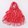 Detail of coral red cashmere scarf with fine fringe tassels and soft texture label - Watermelon red