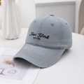 Close-up of grey cotton baseball cap with detailed New York embroidery and stitching - Gray