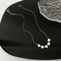 Silver necklace featuring five white Baroque pearls on a thin chain over black surface - 01-G5 Titanium Steel Natural Pearl Necklace Silver