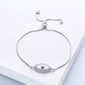 Detail of silver box chain bracelet featuring an evil eye charm with blue zircon stones - Silver