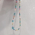 Detail of colorful seed bead necklace featuring a blue starfish pendant and metal clasp - Colorful Beads + Blue Starfish Necklace