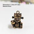 Miniature brass God of Wealth figurine pendant with antique finish for home decor - Ingot Style