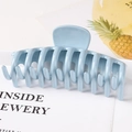 Detail of light blue matte large claw clip with cross-teeth interlocking design - Glossy Blue