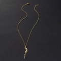 Detail of gold stainless steel necklace featuring a custom Sophia name flower pendant - May Birth Flower (Lily) / Gold