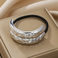 Close-up of elastic hair tie with silver hammered metal detail on silk background - Silver Double Layer Bumpy