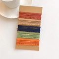 Close-up of assorted elastic hair bands and spiral ropes on a kraft display card - Braid Weave Combination Set