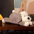 Lying plush puppy toy in grey and cream soft fabric on a cozy wooden table background - Floppy Dog / 35cm