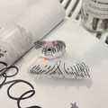 Detail of white marble acrylic hair claw clip featuring a cartoon dog with pink bow tie - Dog with Necklace Claw (approx. 8cm)