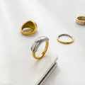 Macro shot of two-tone titanium steel ring with polished gold and silver mirror finish - Long Steel Stitching