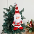 Plush Santa ornament with silver sequins and star hanging on a green Christmas tree - Santa Claus
