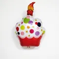 Detail view of a 47cm x 70cm red cupcake foil balloon with colorful polka dots and star patterns - Red Cupcake Balloon