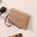 Straw beach clutch bag in beige with wrist strap and zipper on fleece sofa - Coffee