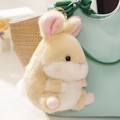 Cute light yellow plush bunny keychain pendant with pink paws hanging on a bag strap - Brown Rabbit