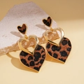 Makroaufnahme von Herzohrringen mit Leopardenmuster und elegantem Goldmetallrand - Herz-Stil