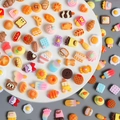Macro shot of assorted miniature resin food charms including colorful bread and cookies - Miniature Food Play Series Random Mix