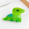 Cute green cartoon dinosaur hair clip with blue spots and yellow swirl patterns - Brachiosaurus