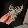 Primer plano de pinza de pelo mariposa dorada con pedrería y perlas sujeta por mano - 3# Perla + Diamante de imitación