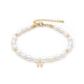Detail of freshwater pearl bracelet featuring a gold letter W charm with small diamonds - Letter W