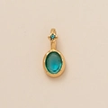 Macro shot of gold pendant with oval turquoise and blue square zircon on textured paper - Oval March (Aquamarine Zirconia)
