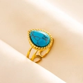 Detailed shot of an adjustable gold ring featuring a teardrop turquoise stone on soft fabric - Gold Base Dark Blue Stone (J550-G-DB)