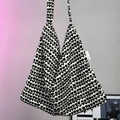 Close-up of black and white tulip pattern on thick knitted tote bag with woven brand label - Black and White Tulip