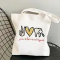 White canvas tote bag featuring Peace Love Dental Hygienist print on a black metal chair - C1 Peace Love Dental