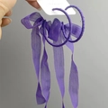 Detail showing oversized purple chiffon ribbon wrapped hoop earrings with long tassels - Purple