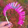 Detailed view of pink crystal wicca crown with silver crescent moon held by hand - AB Rose Red + White K Moon