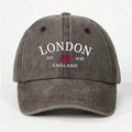 Detailed view of dark grey washed cotton baseball cap with white London England embroidery - Coffee