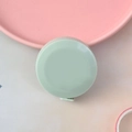 Mini light green circular tape measure for sewing body measurements in sleek plastic - Nordic Green
