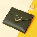 Detail shot of a dark green tri-fold wallet with gold heart buckle on a dual-tone background - Green