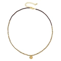 Macro shot of 18K gold-plated beads and textured pendant on a beaded necklace - Antique Red