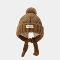 Detail of winter quilted trapper hat with fur pom-poms and Bonjour text label in brown - 52cm 2-5 Years Old / Coffee