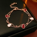 Vista dettagliata di un bracciale a doppio strato in oro rosa con ciondoli a zucca - Braccialetto-Oro Rosa-Rosso / Oro rosa Rosso