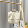 Waterproof beige baby silicone bib with brown crescent moon pattern and food catcher - Moon & Star