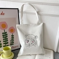 Minimalist beige canvas tote bag with black line cartoon girl print and pink details - White with Winking Girl
