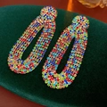 Close-up of vintage drop earrings with colorful rhinestones on green velvet background - Silver Earring Post - Colorful