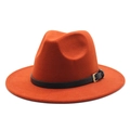 Close-up of burnt orange fedora hat featuring black leather band and gold metal buckle - Caramel color