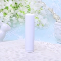 Single white plastic cylindrical lip balm tube on decorative lace for cosmetic packaging - White