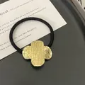 Black elastic ponytail holder with a gold four-leaf clover metal charm and textured finish - 10# Gold Wrinkle Flower