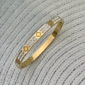 Bracciale in acciaio al titanio dorato con motivo a quadrifoglio e doppia fila di strass - Fila di Diamanti Fiore / Stile Fiore Oro